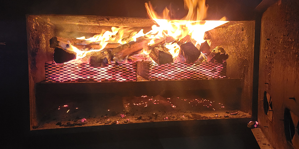 The firepit of a smoker used to smoke meats.
