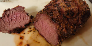 A beef roast that has rested and being sliced.