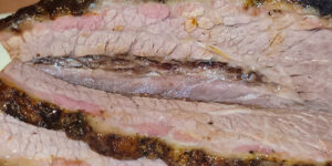 A closeup photo of baked brisket.