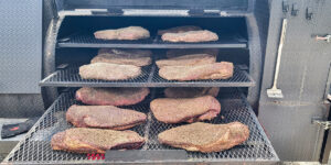 Beef brisket that has been seasoned and is getting ready to be smoked.