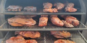 An assortment of meats being smoked.